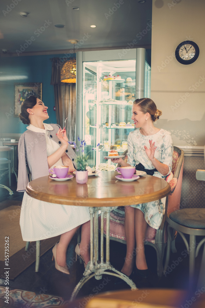 Two elegant young ladies in a cafe Two elegant young ladies in a cafe