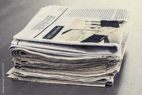 Stack of newspaper on wooden table