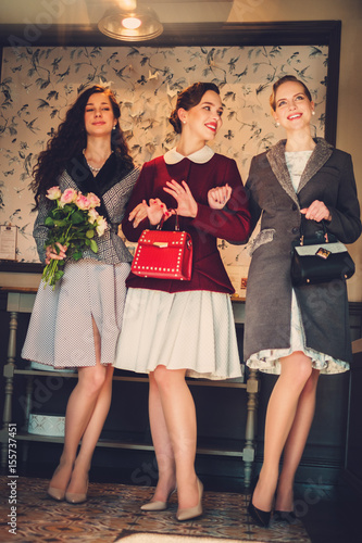 Three elegant young ladies ready for a party