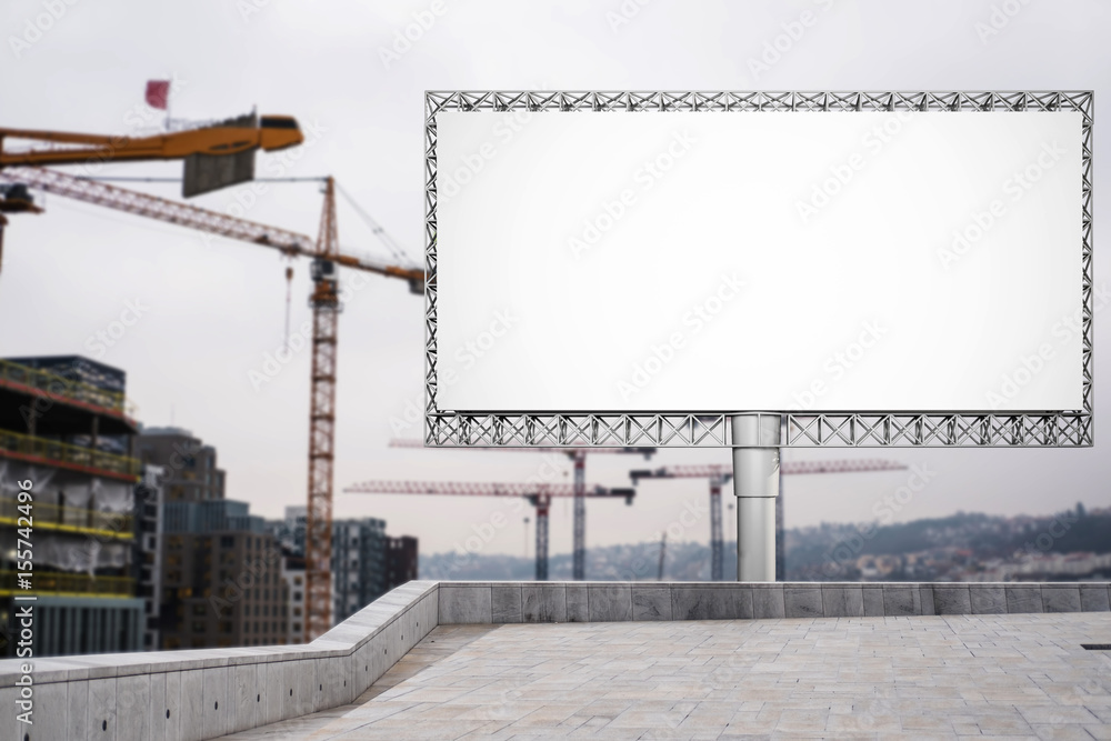 Blank billboard for advertisement at in the city with construction crane Blank billboard for advertisement at in the city with construction crane
