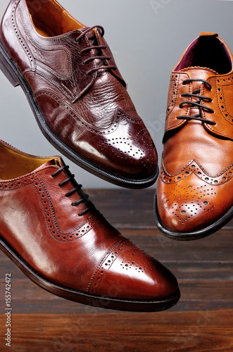 Fashion classical polished men's brown oxford brogues shades of brown oxford brogues.Conept flying shoes.Closeup