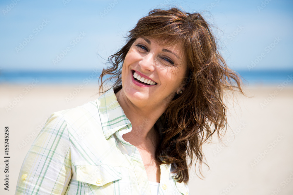 Pretty middle aged woman on the beach