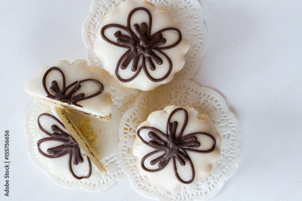 Homemade sandwich cookies with jam and glaze on white background Homemade sandwich cookies with jam and glaze on white background