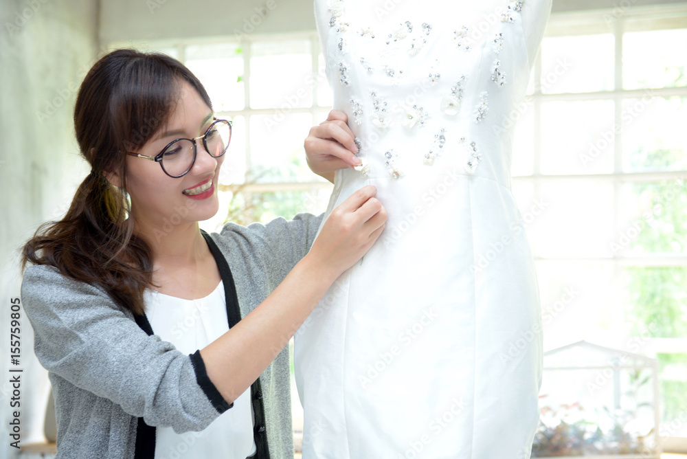 Teamwork designer concept : Fashion designer working near mannequin in office