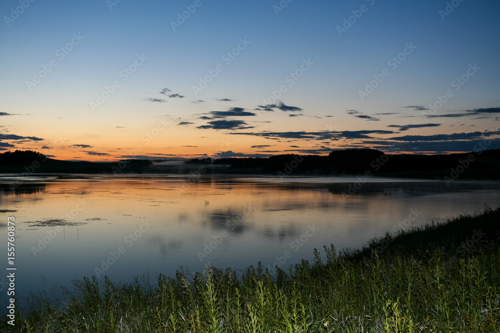 Fototapeta premium Summer landscape. Evening sky and river after sunset.