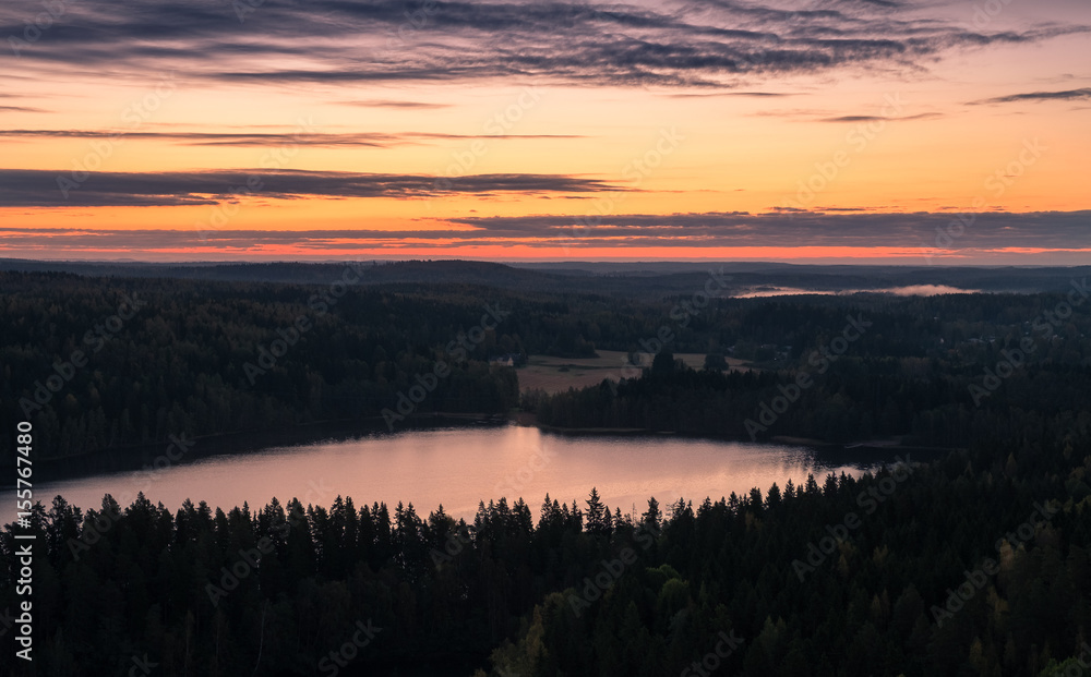 Scenic landscape before sunrise with lake at autumn in national park Finland