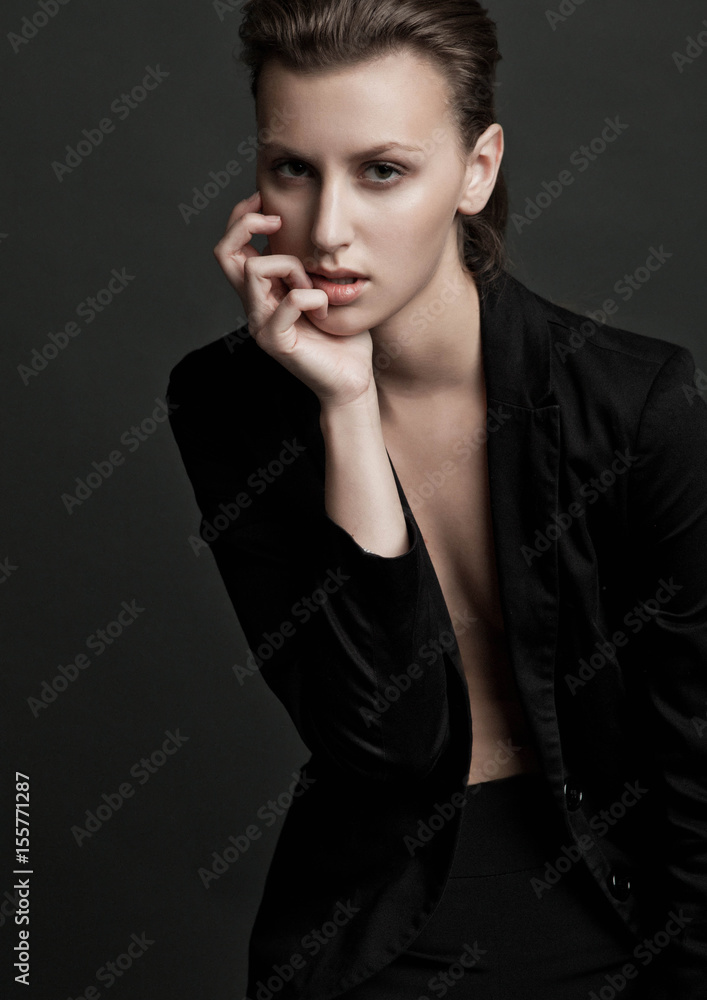 Beautiful fashion model wearing black ladies suit