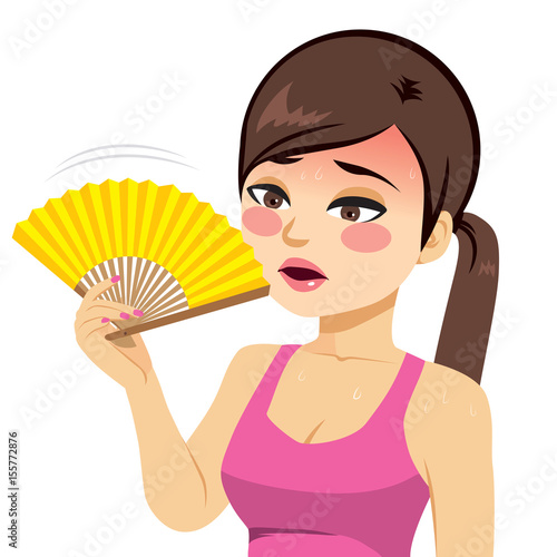Young beautiful woman heated fanning with yellow fan