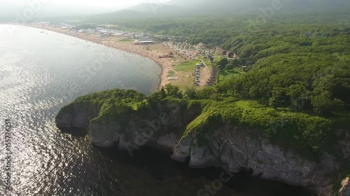 Bay Cote azure Shamora Vladivostok Russia Primorsky City long beach people swimming recreation area Wave rock Cape Beautiful nature blue water sea ocean. Summer sunny. Aerial drone turn with approach photo