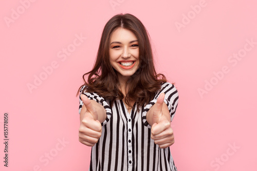 Smiling girl showing thumbs up
