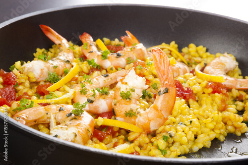 Delicious paella in pan with shrimps