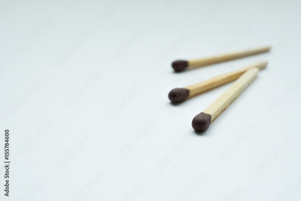 Matches over white background. Closeup shot. Shallow depth of field. Matches over white background. Closeup shot. Shallow depth of field.