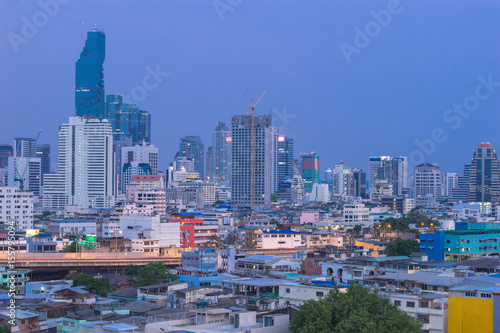 The beautiful scenery of tall buildings in the capital after sunset. City growth is being compared between residential and business districts. © Surapong