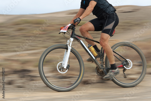 Motion blur of a mountain bike race with the bicycle and rider at high speed