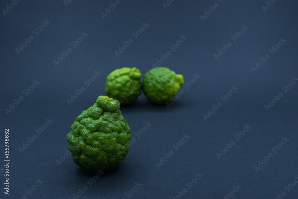 Kaffir Limes over black background. Shallow depth of field. Kaffir Limes over black background. Shallow depth of field.