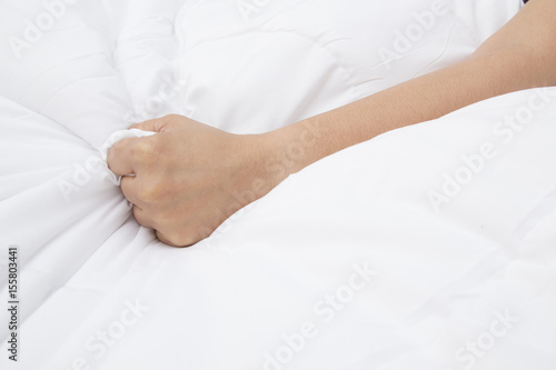 hand of women pulling white sheets in ecstasy, orgasm.