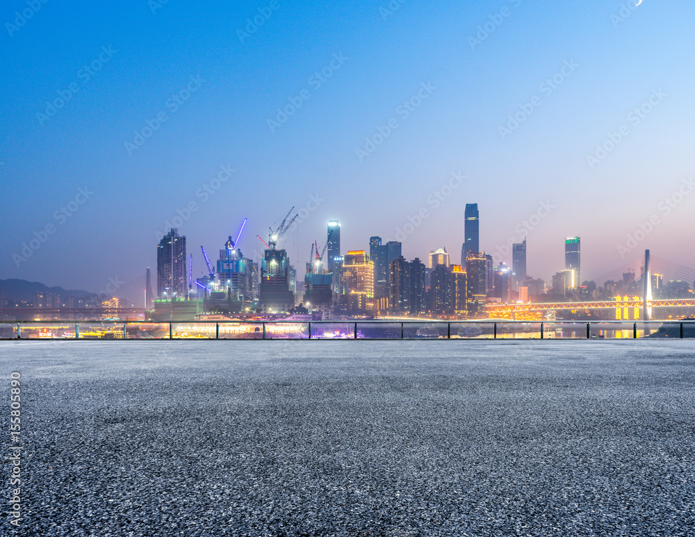 Fototapeta premium cityscape and skyline of chongqing from empty brick floor at night