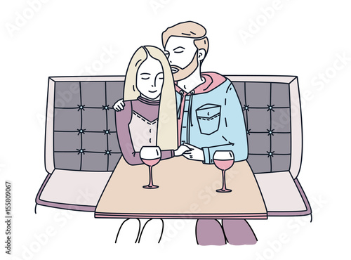 Young couple sits in a cafe and drinks wine