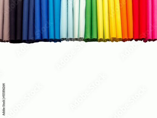 Stack of colorful spectrum t-shirts, folded 2 for each color t-shirts on white background. top view
