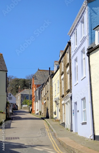 Picturesque English seaside village street on a bright sunny day with blue sky