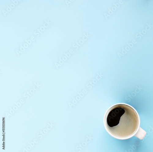Morning hot coffee in cup on blue background,copy space,Top view,flat lay,minimal style