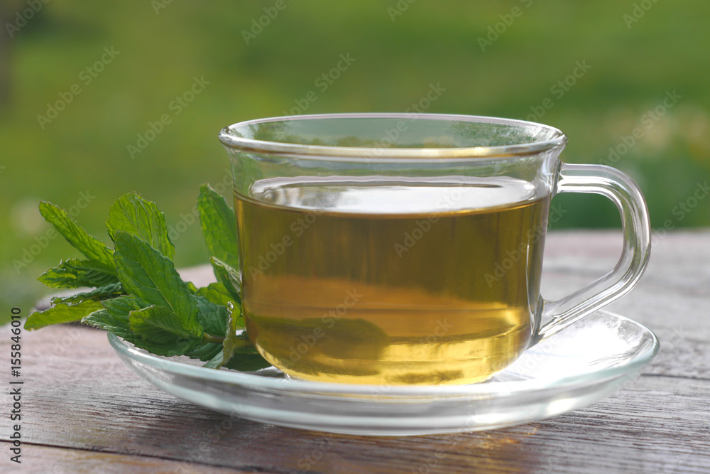 Glass cup of mint tea with mint leaves Glass cup of mint tea with mint leaves