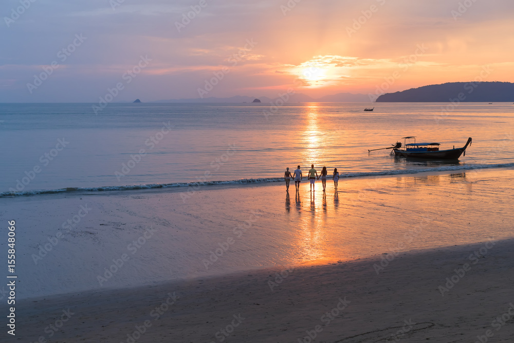 People On Beach At Sunset In Thailand, Young Tourist Group Walking On Sea In Evening While Asia Summer Vacation