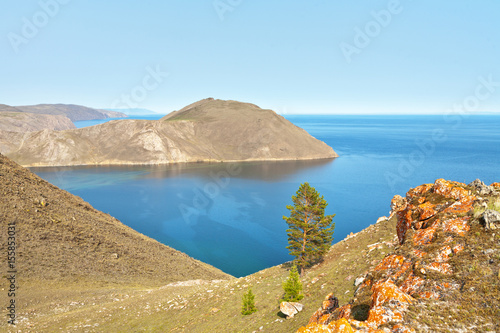 The western shore of Lake Baikal. The top view of the bay at the mouth of the Anga River on a summer day