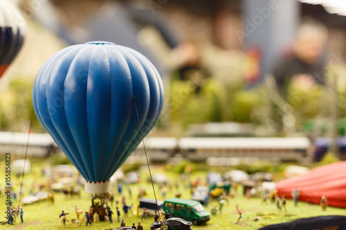 City in miniature. Model of a balloon with a basket or montgolfier ready to take off from the ground using tilt-shift telephoto lens