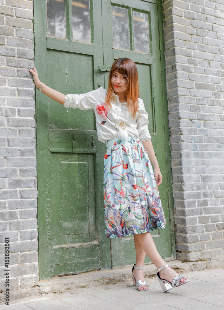 Young woman leaning against a door Young woman leaning against a door