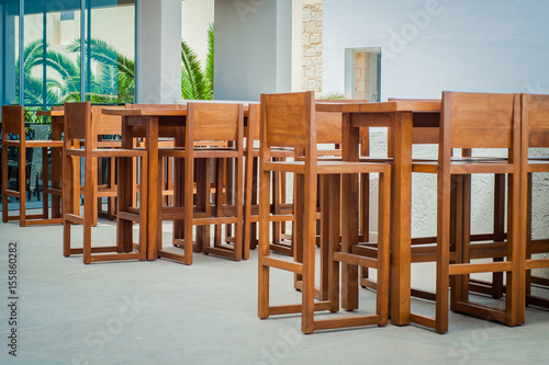 Obraz na płótnie Wooden tables and chairs in seaside Greek restaurant w salonie