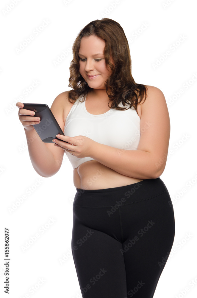 Smiling fat athletic woman with tablet Smiling fat athletic woman with tablet