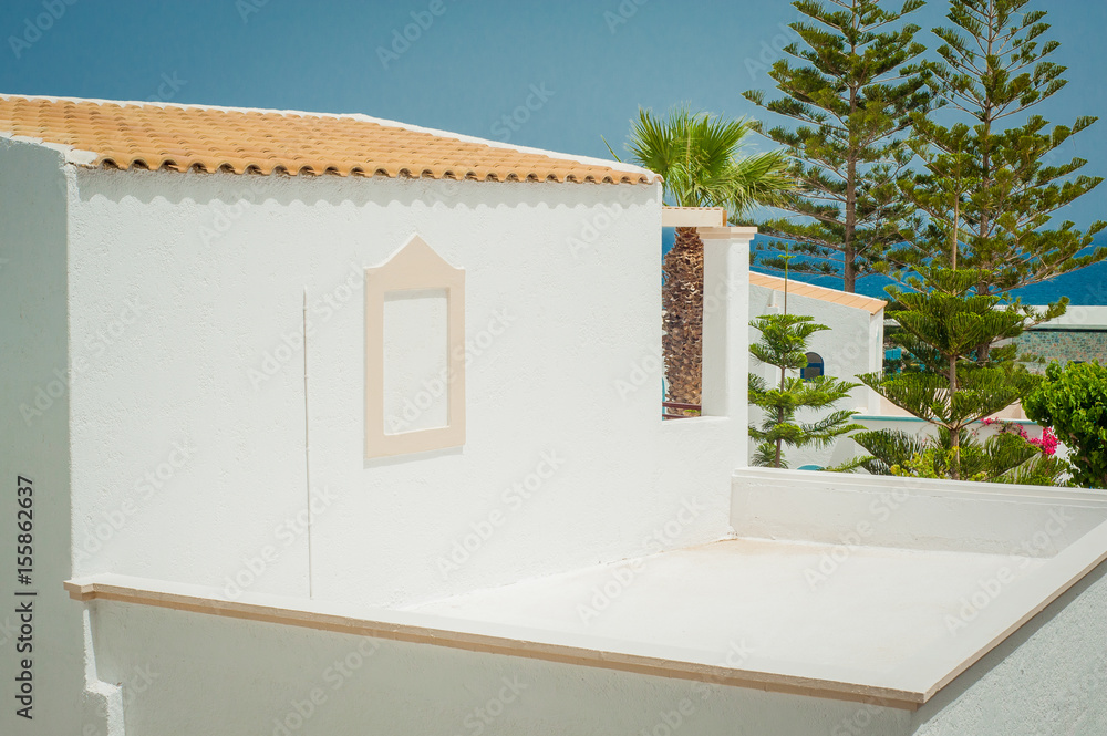 Greek architecture - white buildings, sea and red windows, tree