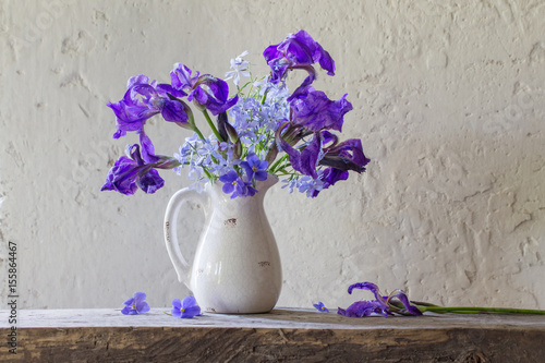 Fototapeta Naklejka Na Ścianę i Meble -  beautiful bouquet with irises on wooden table