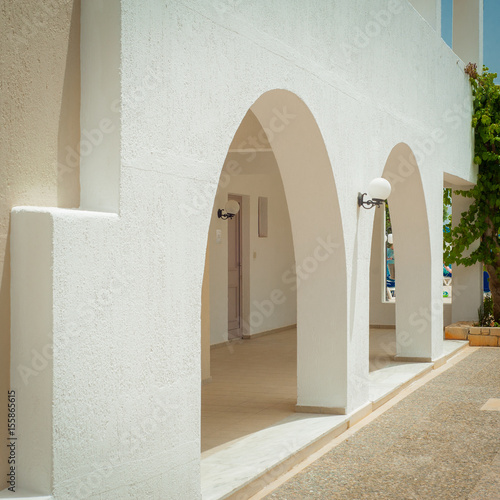 Greek architecture - white buildings, sea and blue windows, tree and flower