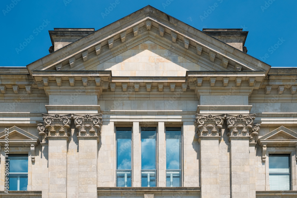 Classical building exterior detail with columns and stucco