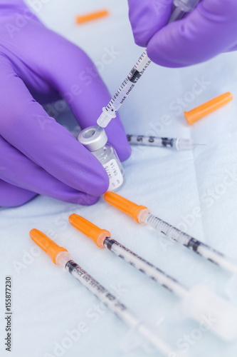 Cosmetic Surgeon Doctor Filling Botox Syringe From Vial