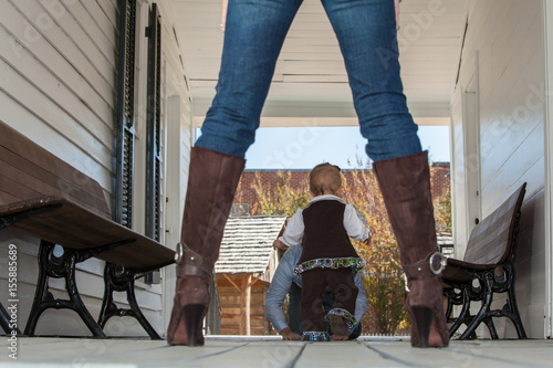 Toddler Seen through the Frame of Mom's Legs