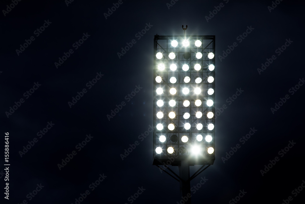 Fotografie Stadium lights against dark night sky background