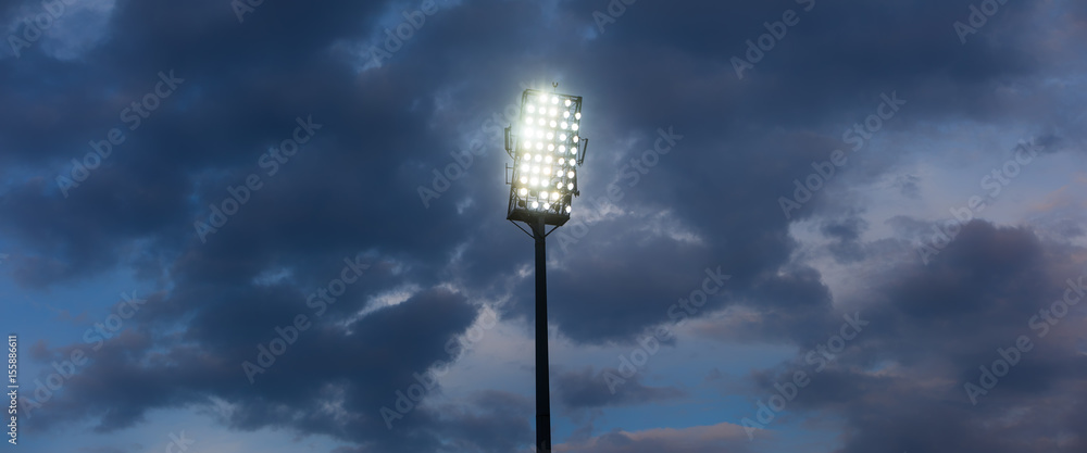 Stadium lights against dark night sky background Stadium lights against dark night sky background