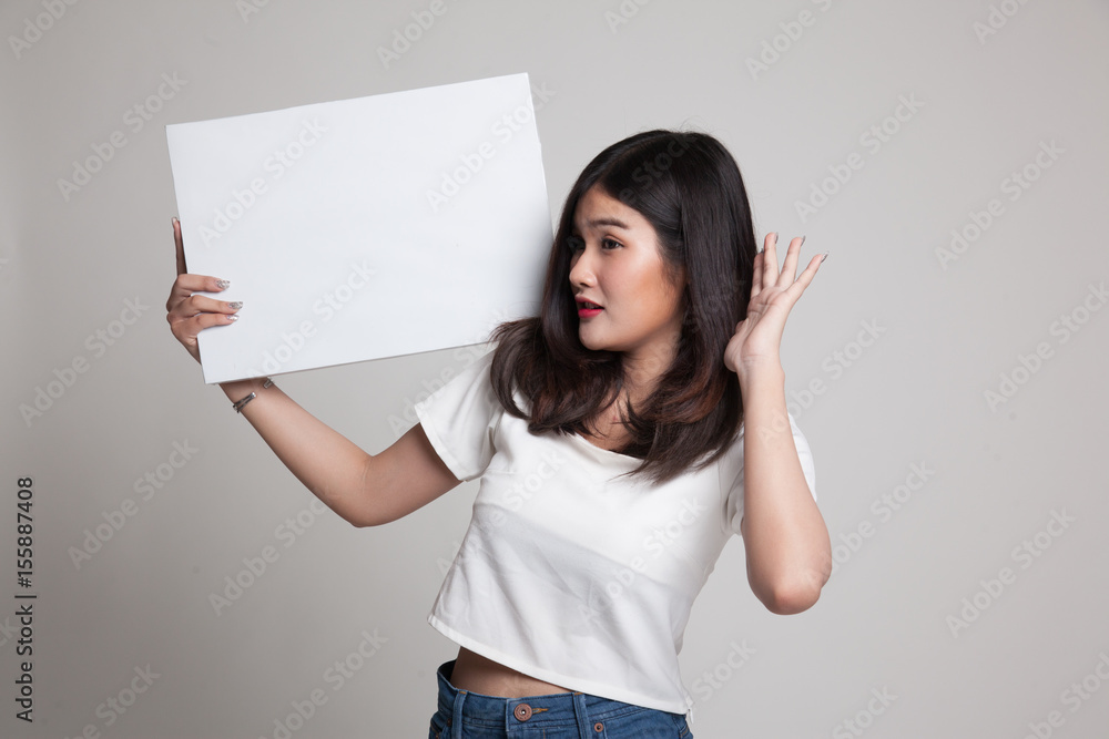 Young Asian woman surprise with white blank sign. Young Asian woman surprise with white blank sign.