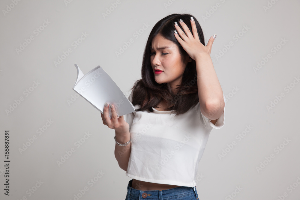 Young Asian woman got headache read a book. Young Asian woman got headache read a book.