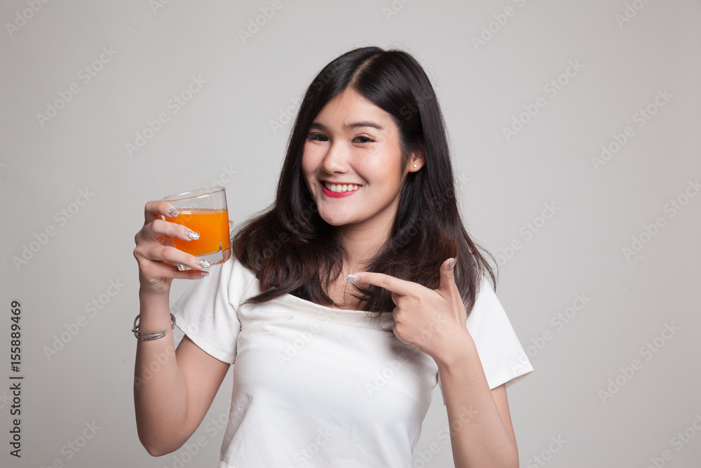 Young Asian woman point to orange juice. Young Asian woman point to orange juice.