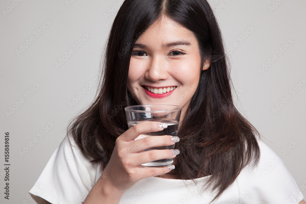 Young Asian woman with a glass of drinking water. Young Asian woman with a glass of drinking water.