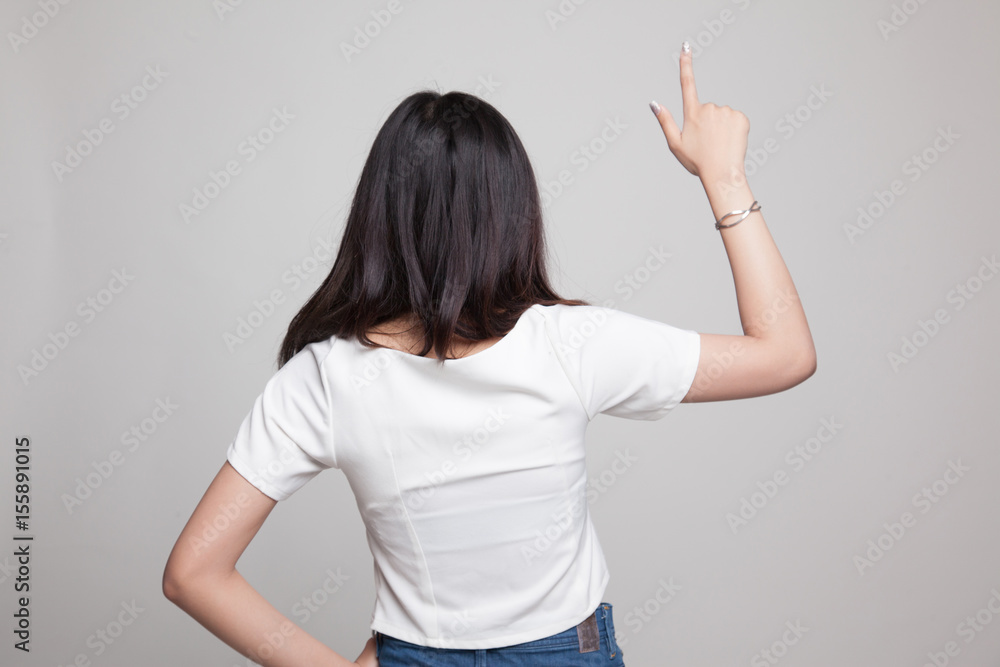 Back of Asian woman touching the screen with her finger. Back of Asian woman touching the screen with her finger.
