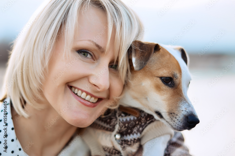 Beautiful blonde girl with a smile and a dog. Happy face Beautiful blonde girl with a smile and a dog. Happy face