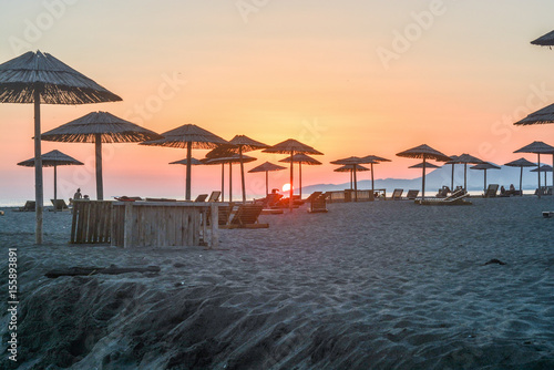 Fototapeta Naklejka Na Ścianę i Meble -  end of a day - sunset, ocean, beach, sky, sun, sand, parasol, summer