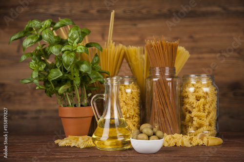 Dry pasta with ingredients on a old wood