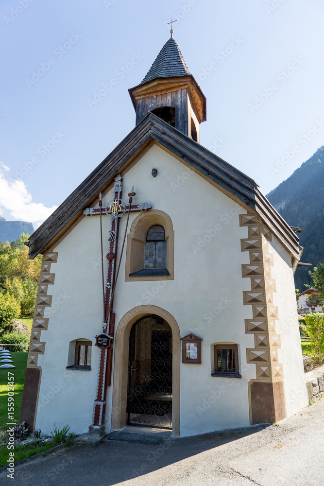 Landscape protection area Achstürze. Blasius chapel in Oetz-Piburg, alps in background. Tirol oldest nature preserves. Oetz alps, unique cultural mountains landscape, Lake Piburger See, Ötztal valley.