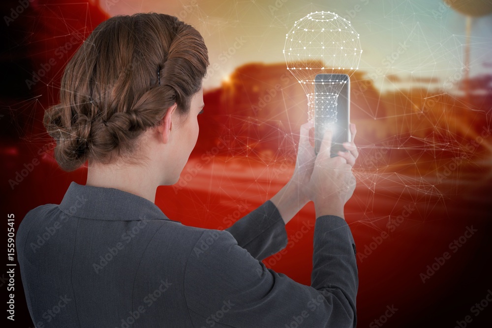 Plakat Composite image of businesswoman using mobile phone